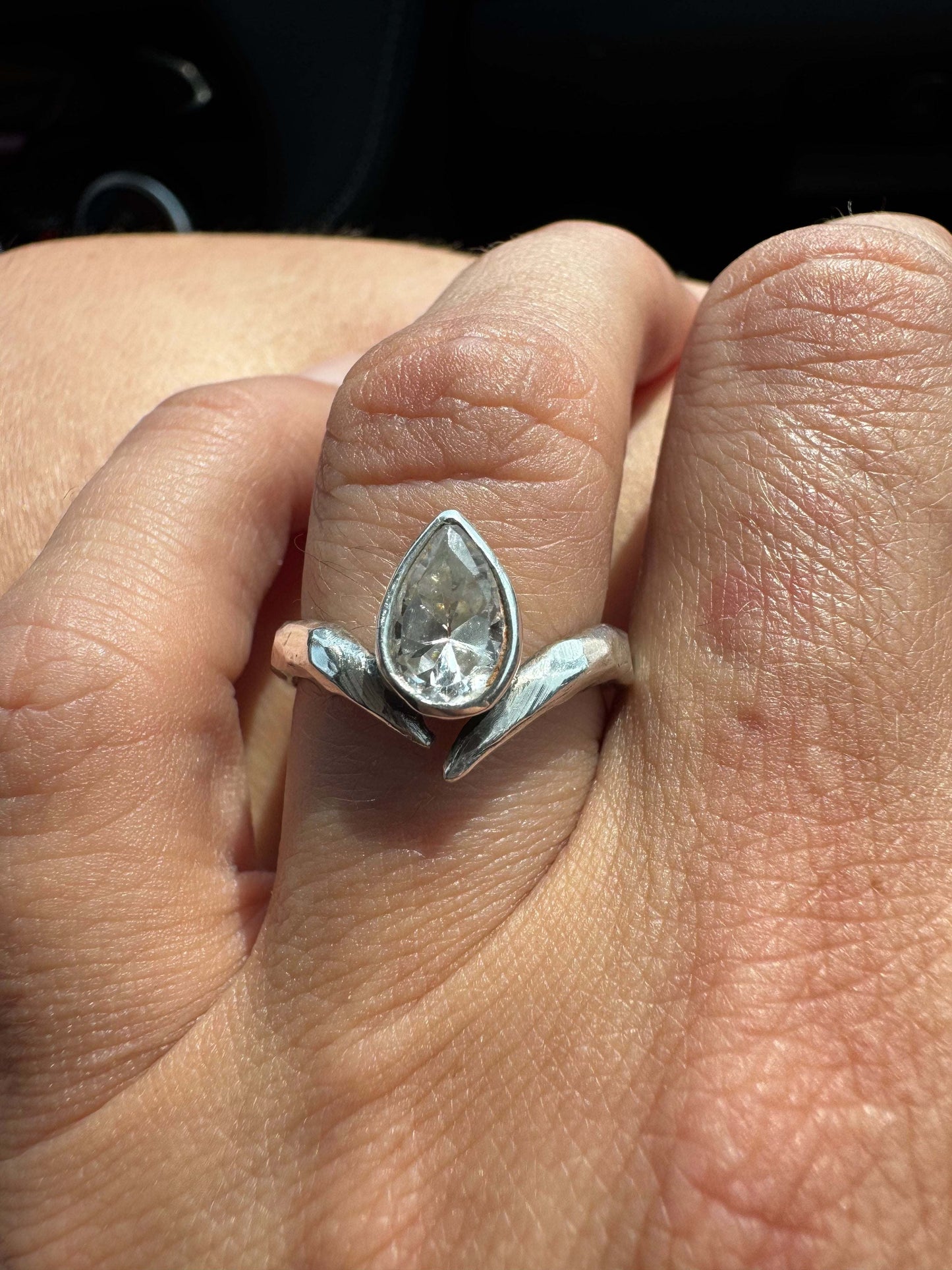 Asymmetrical band with pear bezel in sterling silver