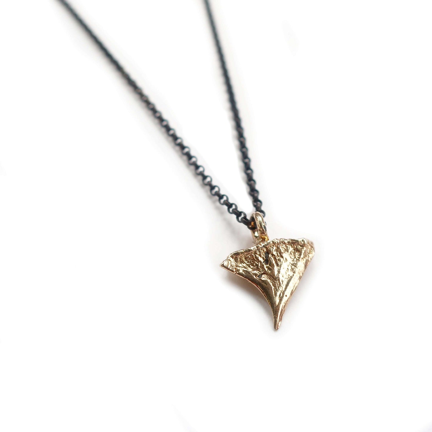 14K rose thorn pendant in yellow gold on oxidized silver chain symbolizing resilience and protection