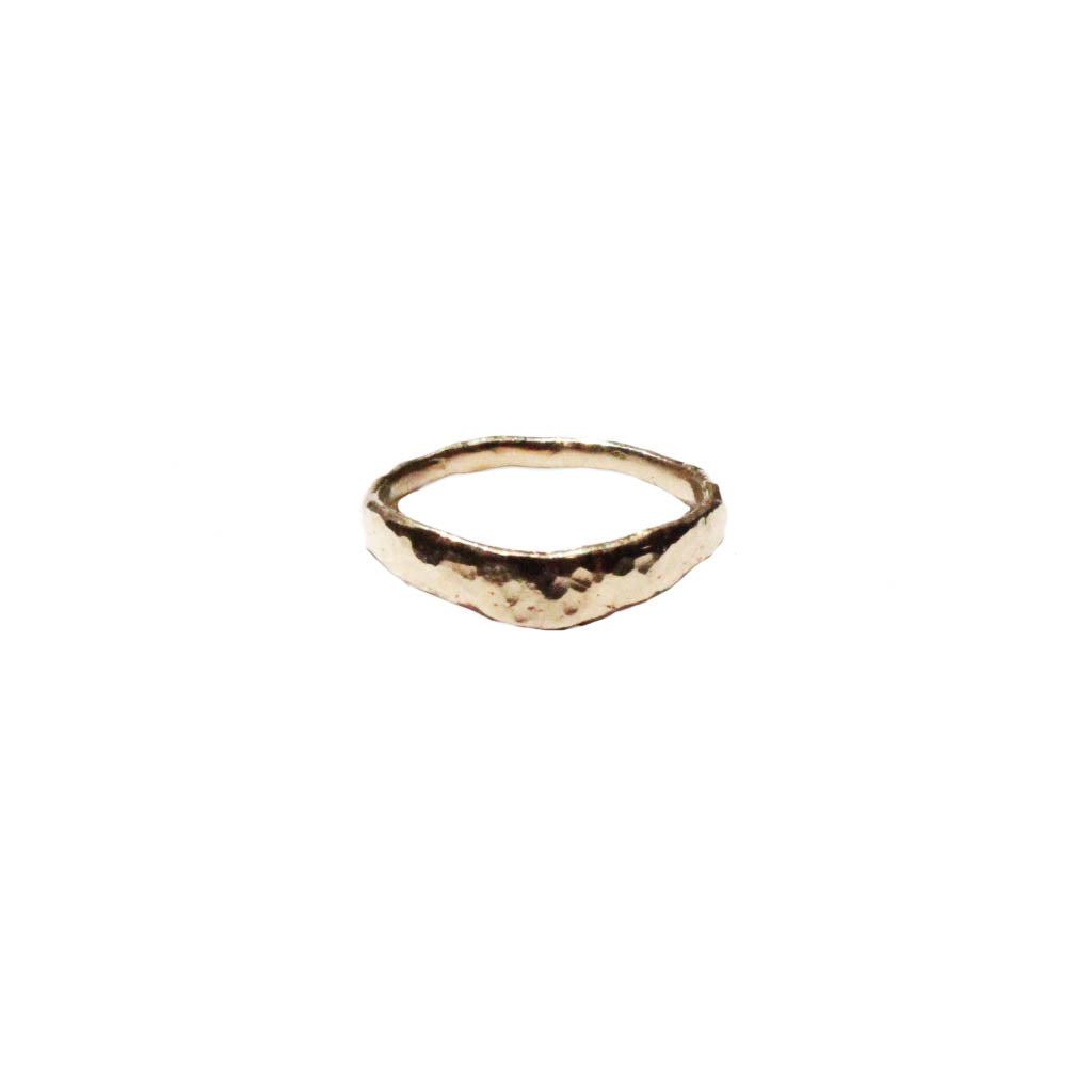 Thick curved textured gold stacking band ring isolated on white background