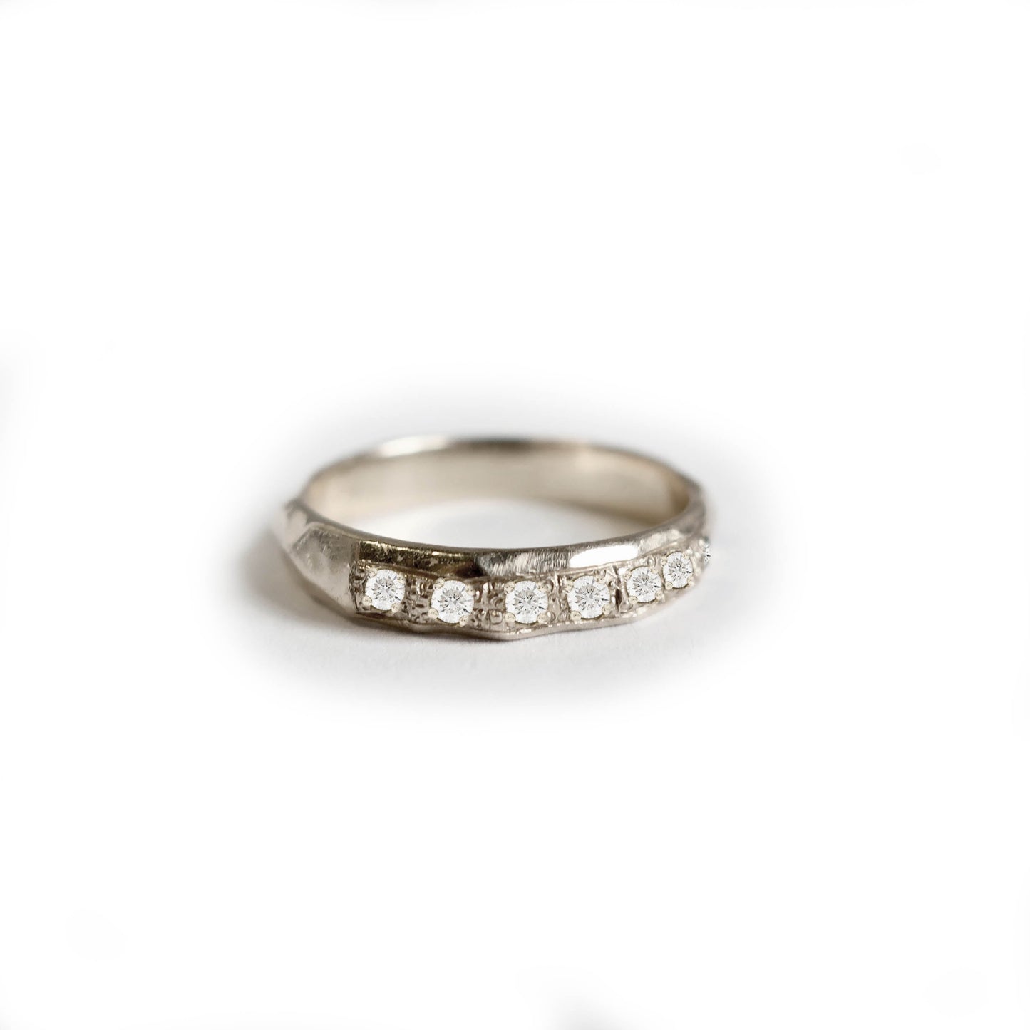 Diamond hammered band in solid 14k gold with seven pave diamonds and hammered texture