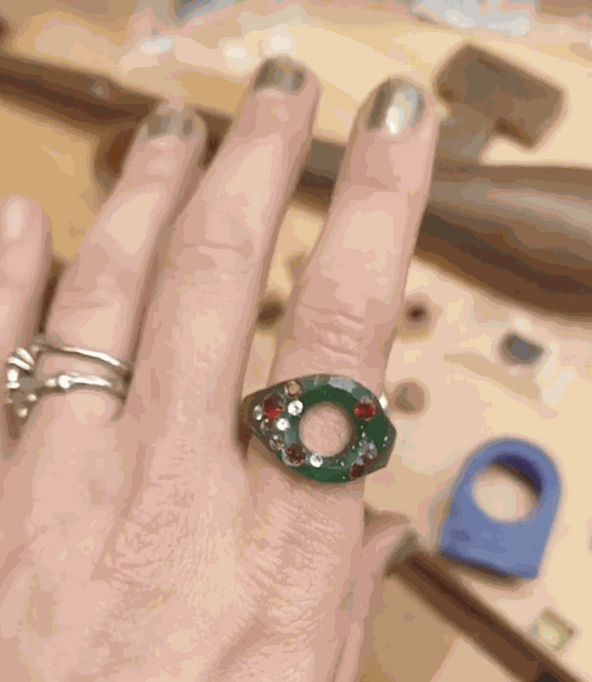 artisan carving intricate wax model for jewelry making process